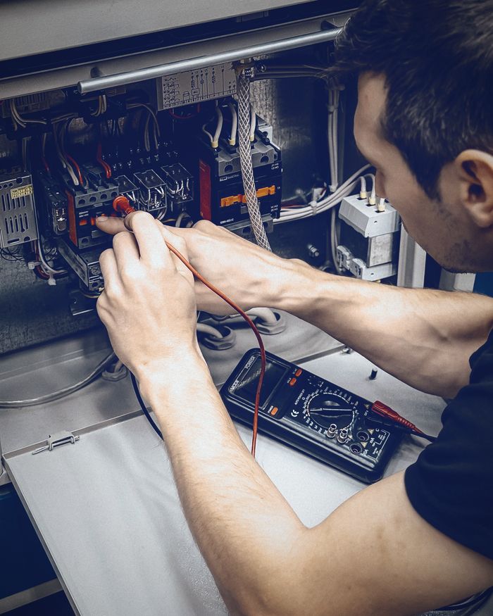Electrician testing a circuit with a multimeter