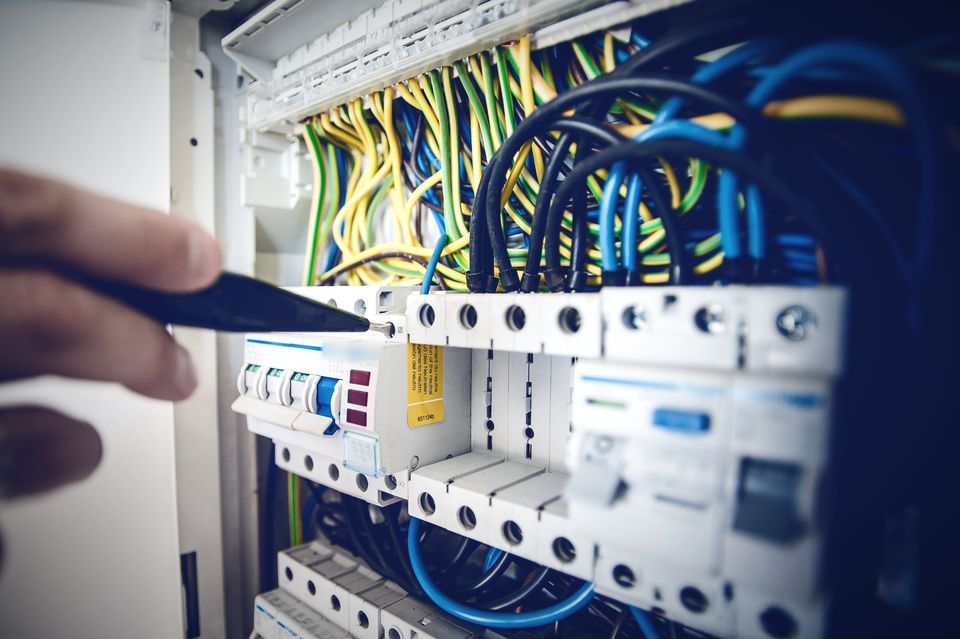 Electrician working on an opened switchboard